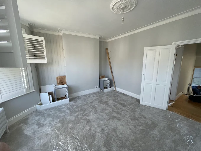 Freshly decorated reception room with new carpet, restored cornicing and ceiling rose